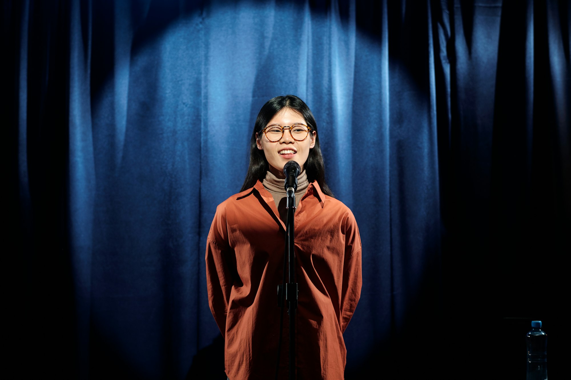 Young Chinese female comedian on stage